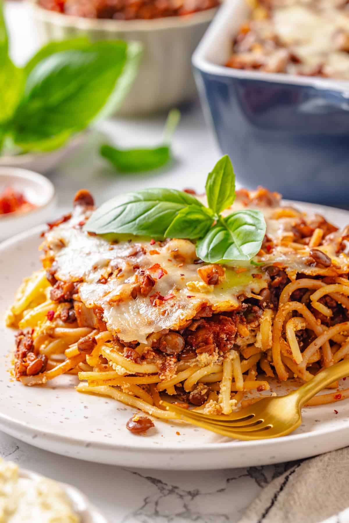 Portion of million dollar spaghetti on plate with fork.