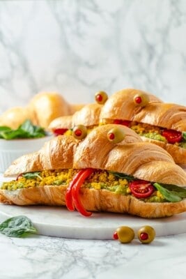 Two monster breakfast sandwiches on marble board