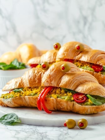 Two monster breakfast sandwiches on marble board