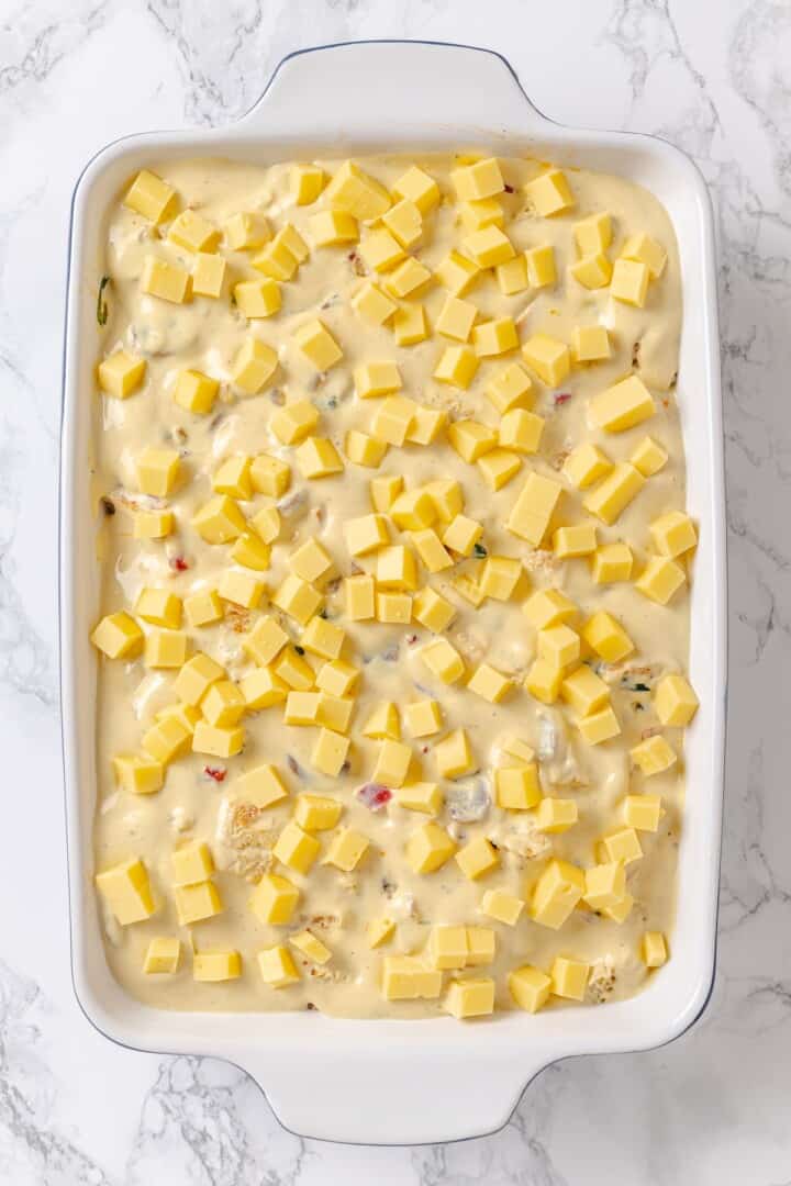 Overhead view of vegan overnight breakfast strata in baking dish before baking