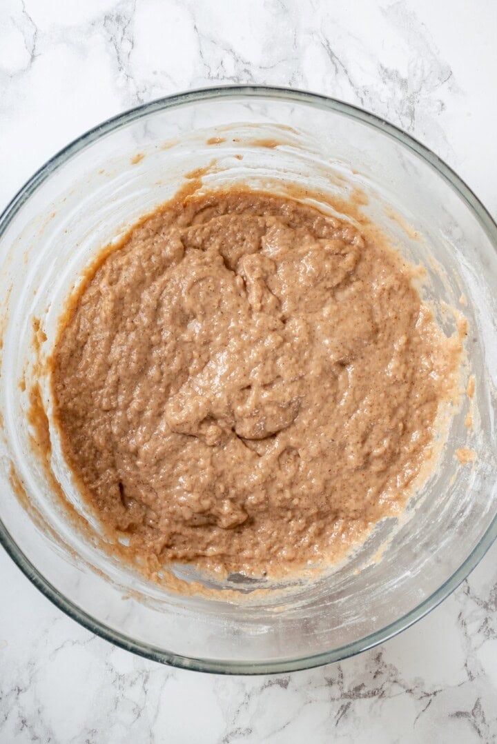 Batter for vegan apple cider donuts in glass bowl.