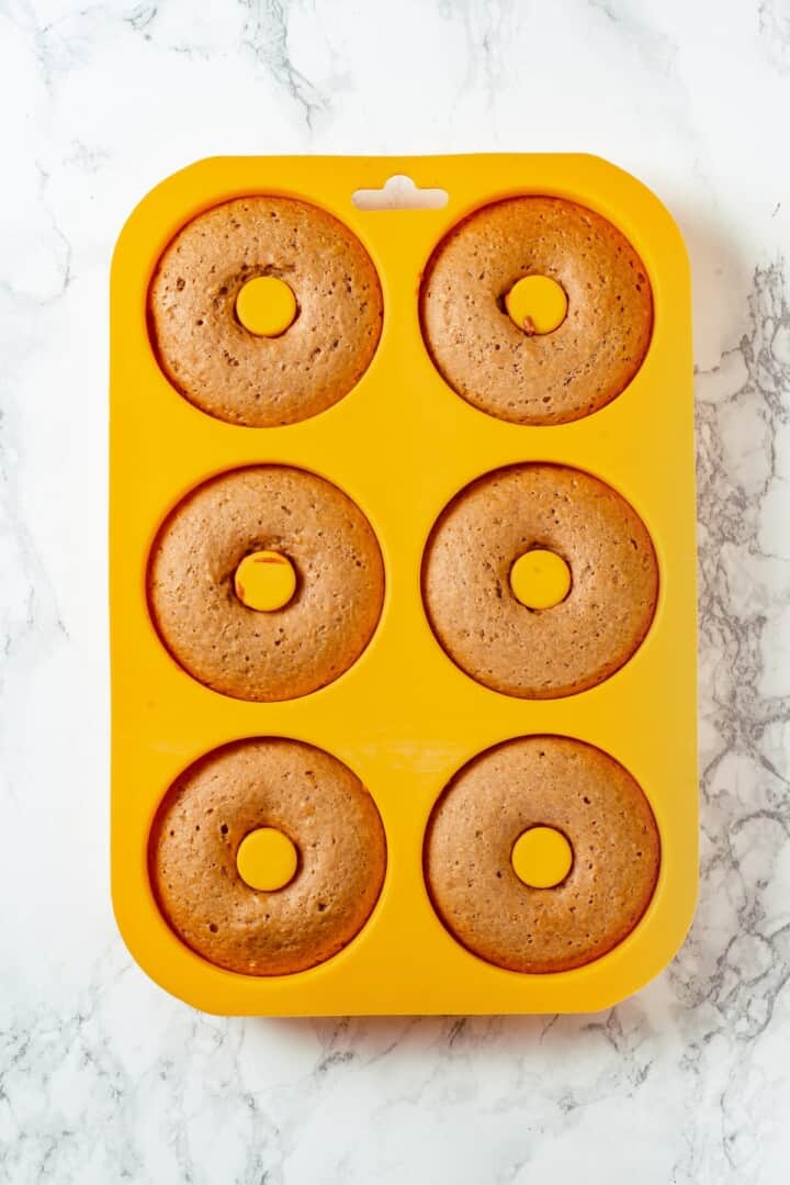 Baked apple cider donuts in silicone pan.