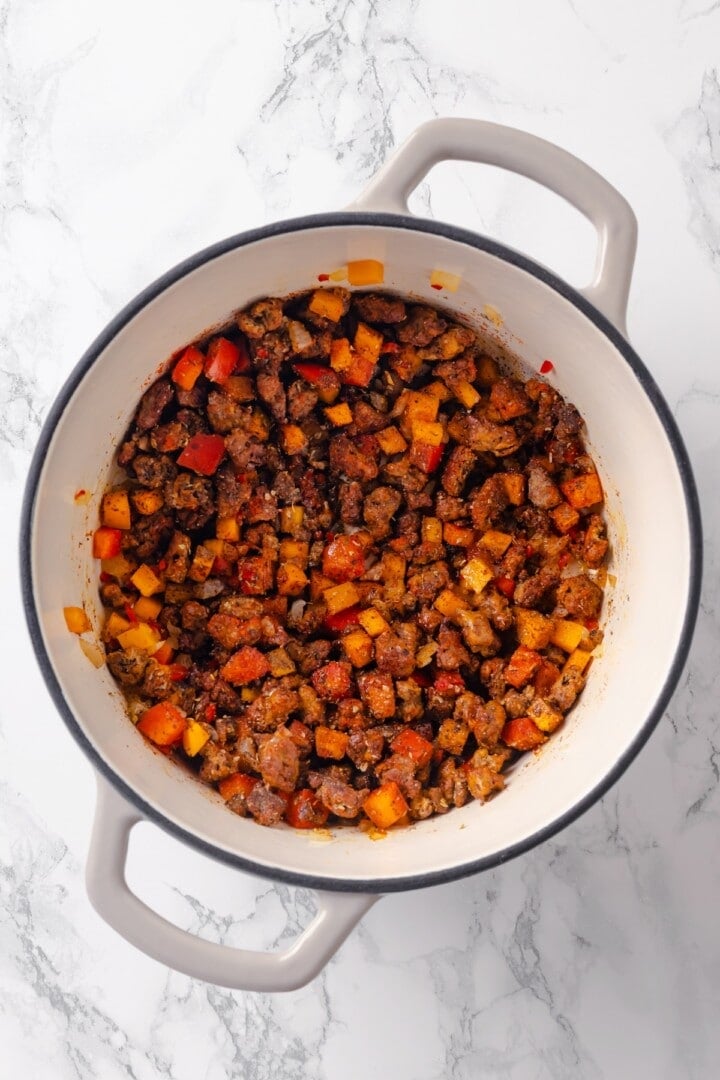 Vegan ground beef and vegetables sauteing in pot.