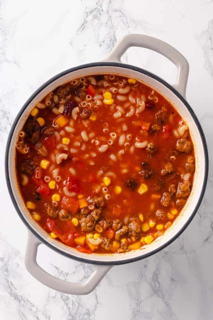 Elbow noodles added to pot of chili mac and cheese.