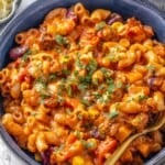 Bowl of vegan chili mac and cheese with fork.
