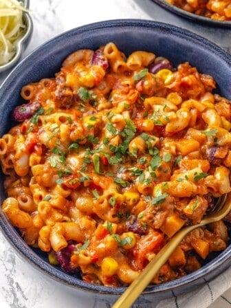 Bowl of vegan chili mac and cheese with fork.
