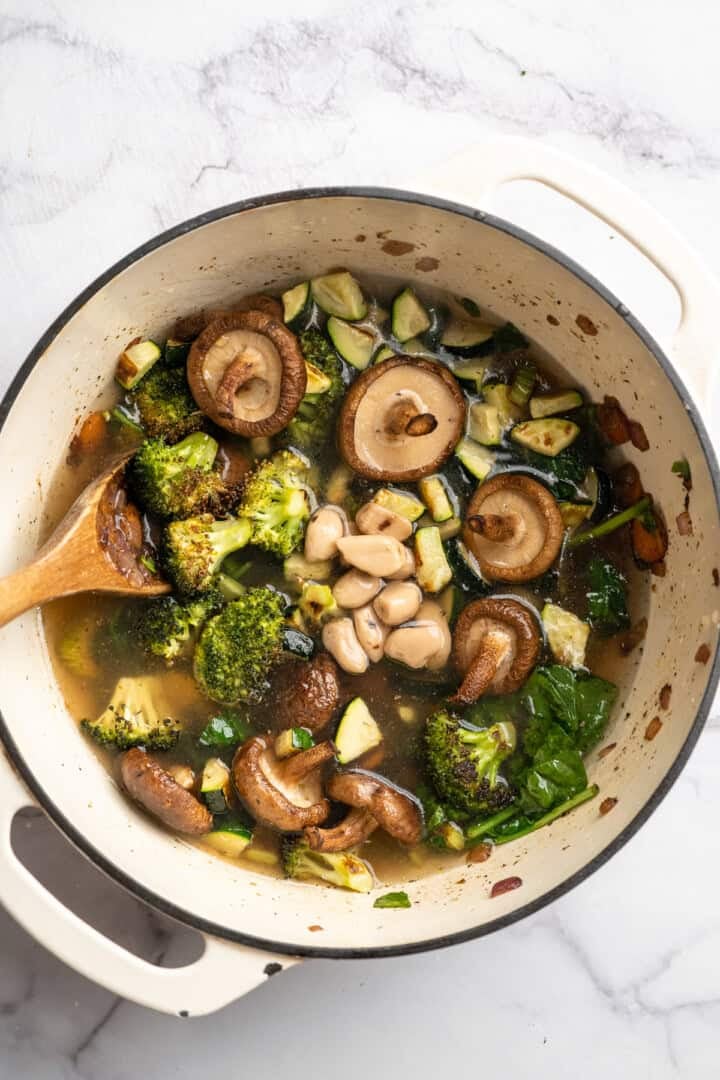 Eliminate waste and make a delicious dinner with this Broccoli Fridge Clean-Out Soup! Rich and creamy, with optional grilled cheese croutons. Roasted vegetables and broth added to Dutch oven for soup.