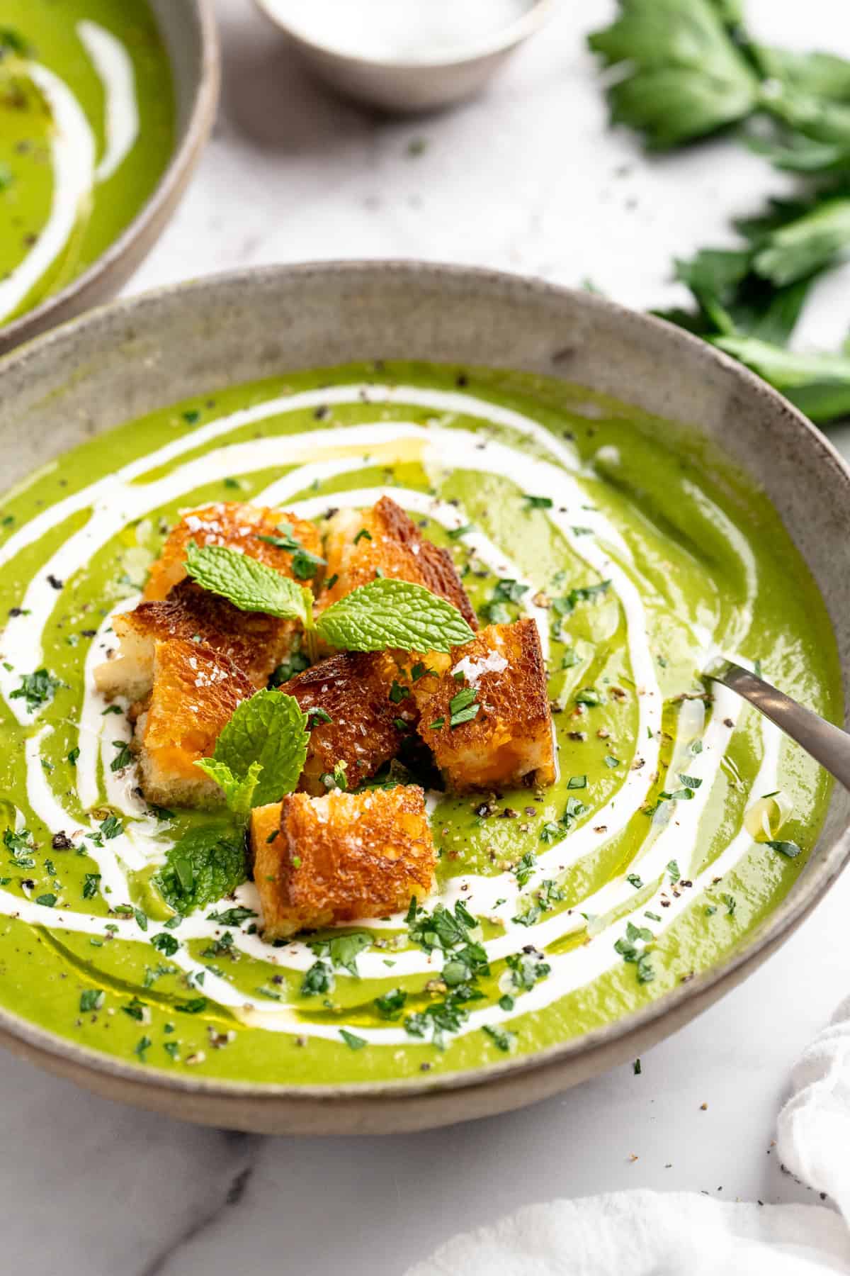 Eliminate waste and make a delicious dinner with this Broccoli Fridge Clean-Out Soup! Rich and creamy, with optional grilled cheese croutons. Creamy broccoli fridge clean-out soup in bowl with grilled cheese croutons.