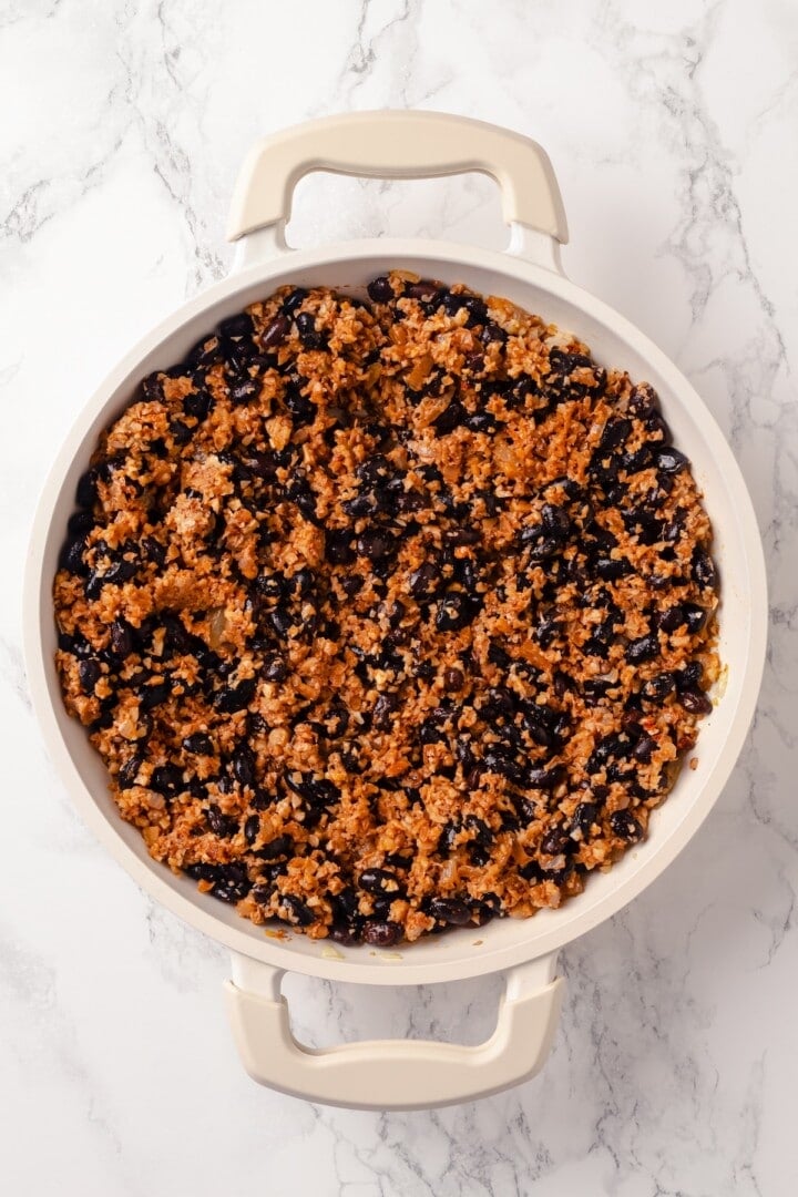 This Stuffed Pepper Soup is a satisfying vegan meal, with walnut “meat,” green peppers, rice and veggies in a rich tomato broth. Delicious! Walnut black bean meat in skillet.