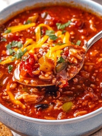 Spoonful of stuffed pepper soup in bowl.