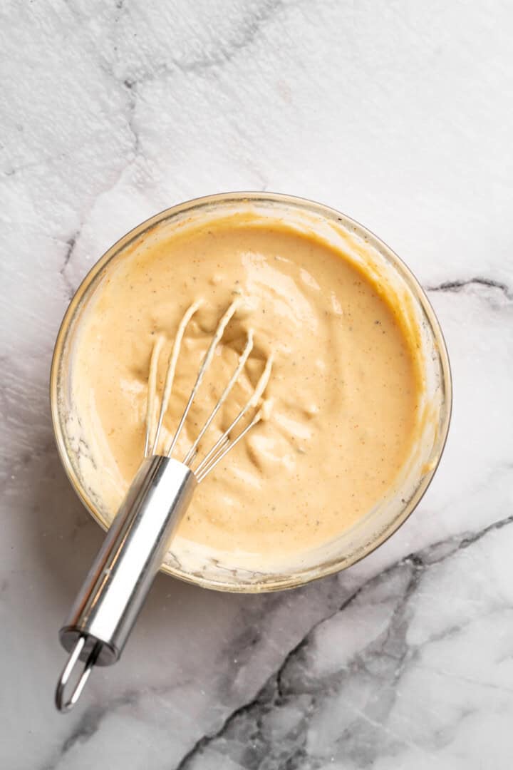 Burger sauce in bowl with whisk.