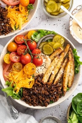 Vegan cheeseburger bowl with fries and burger sauce.