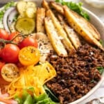 Vegan cheeseburger bowl with fries.