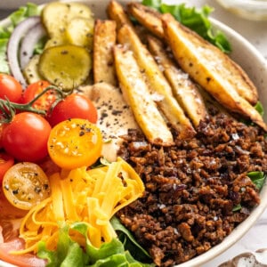 Vegan cheeseburger bowl with fries.