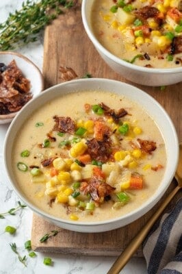 Two bowls of vegan corn chowder with bacon.
