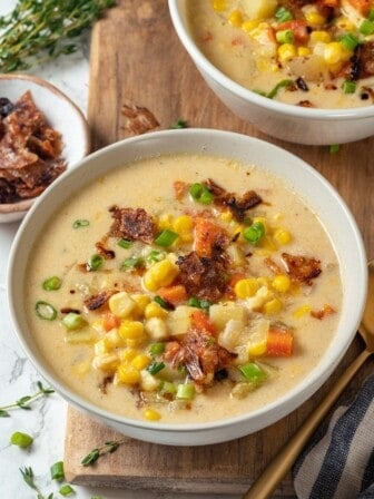 Two bowls of vegan corn chowder with bacon.
