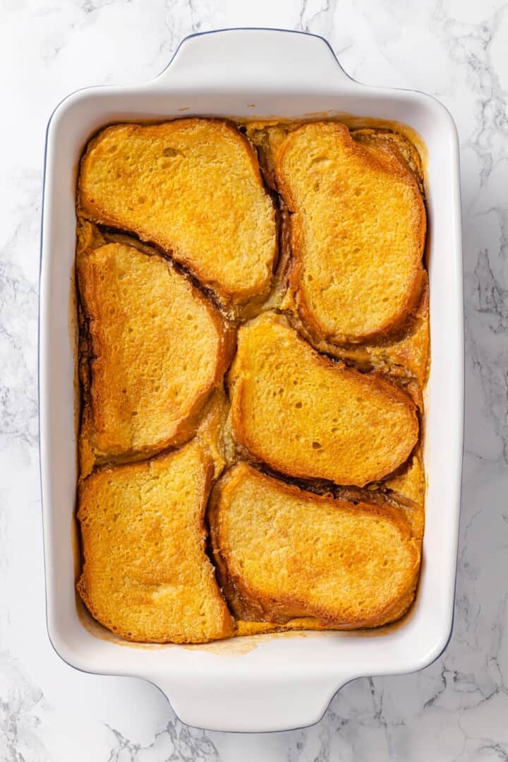 With a rich vegan custard and caramel, this Creme Brûlée French Toast has the flavour of the classic dessert in crowd-pleasing breakfast form! Vegan creme brulee French toast in baking dish before adding caramel.