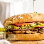 Vegan grinder sandwich on wooden board.