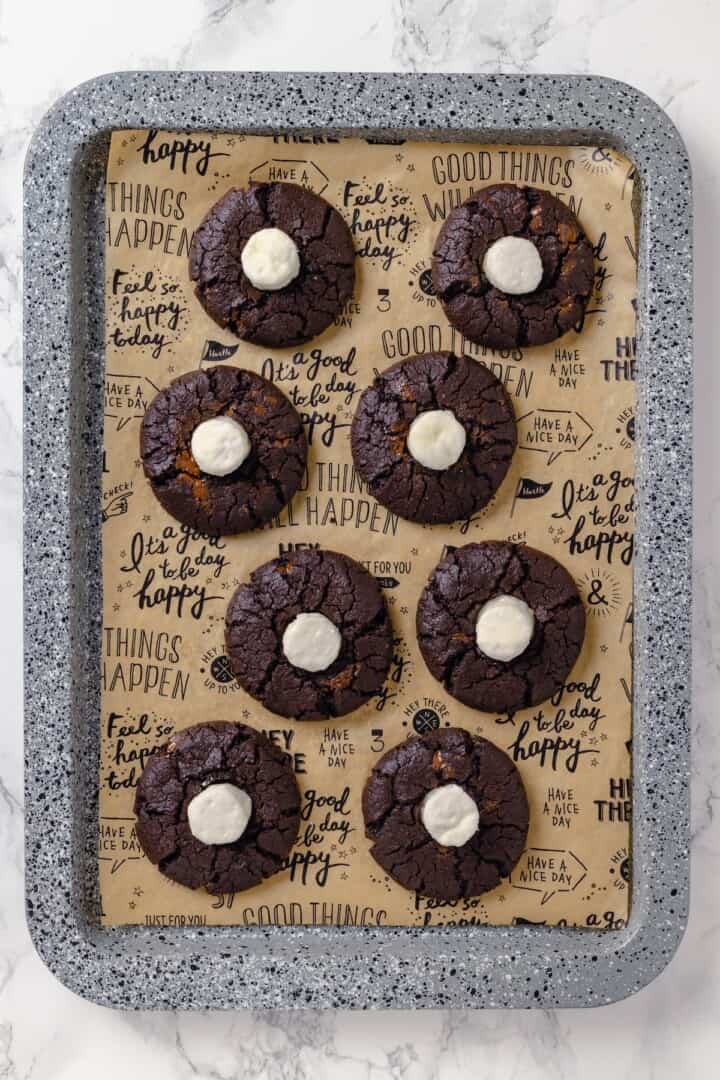 Hot chocolate cookies on parchment-lined pan.