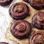 Vegan hot chocolate cookies topped with chocolate and sprinkles.