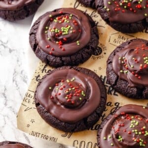 Vegan hot chocolate cookies topped with chocolate and sprinkles.