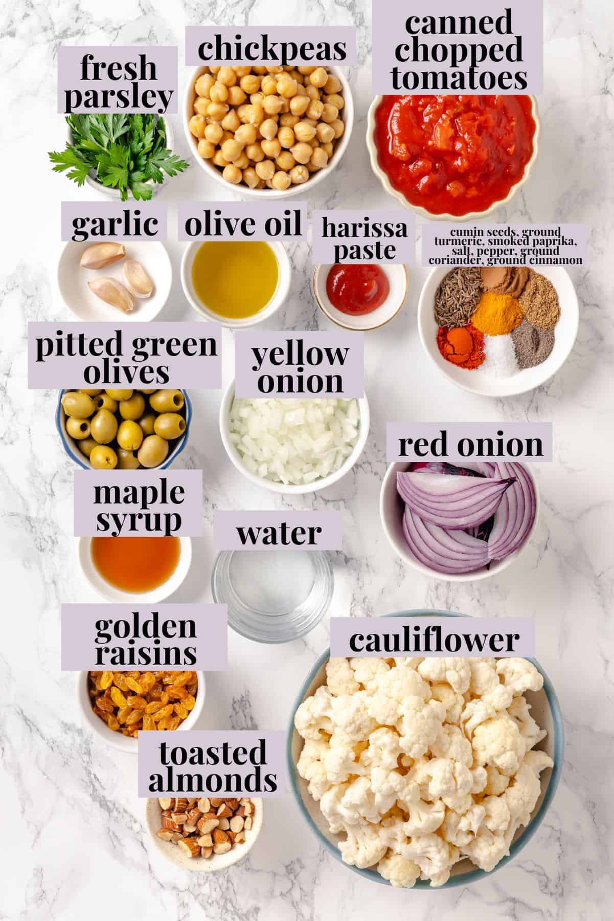 Warm spices mingle with vegetables, golden raisins, olives and chickpeas to make this Moroccan Cauliflower Tagine a delicious vegan dinner! Ingredients for Moroccan cauliflower tagine with labels