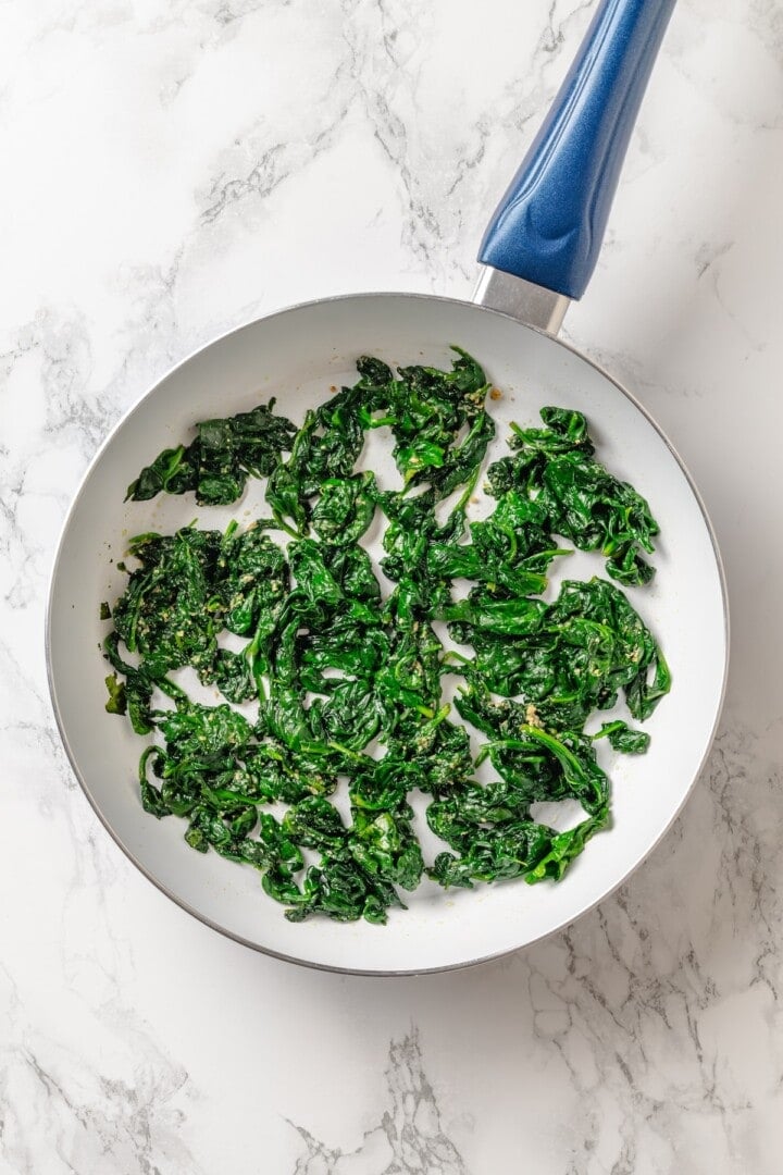 With layers of creamy squash, spinach ricotta and vegan cheese, this butternut squash lasagna is hearty, rich and full of cozy fall flavour! Spinach cooked in skillet.