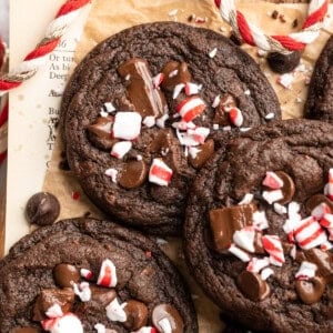 Peppermint chocolate cookies piled on parchment paper.