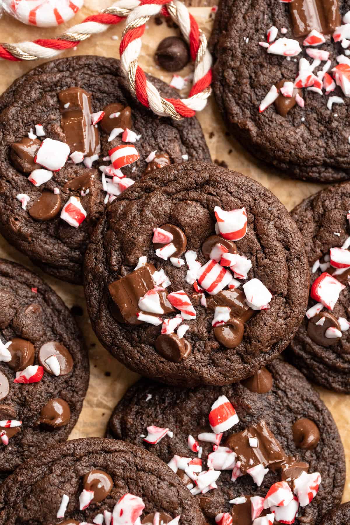 Chewy peppermint chocolate cookies piled on parchment paper.