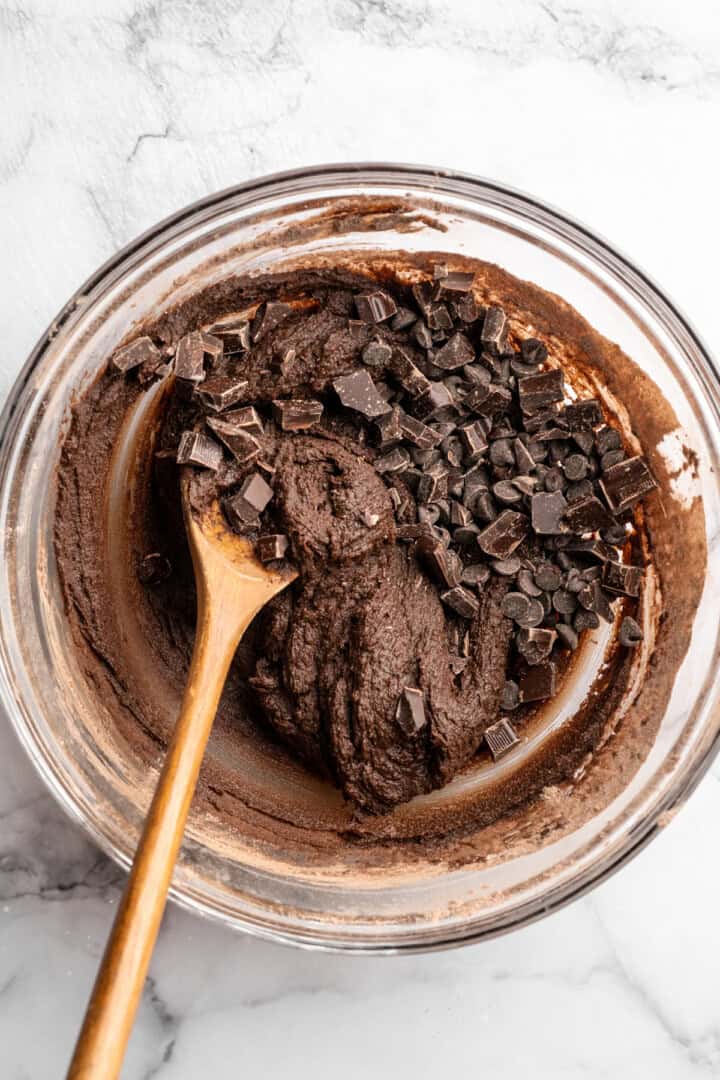 Chocolate chunks added to cookie dough.