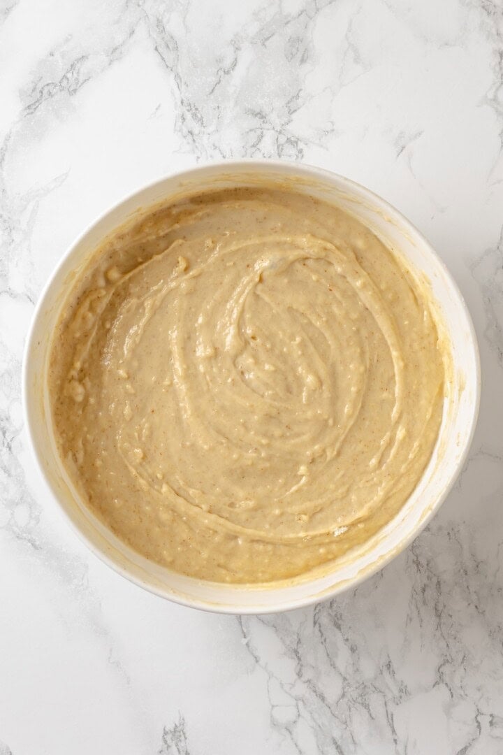 This vegan coffee cake recipe is a bakery-style treat! Moist and tender, with a cinnamon swirl and irresistible crumb topping. Delicious! Coffee cake batter in mixing bowl.