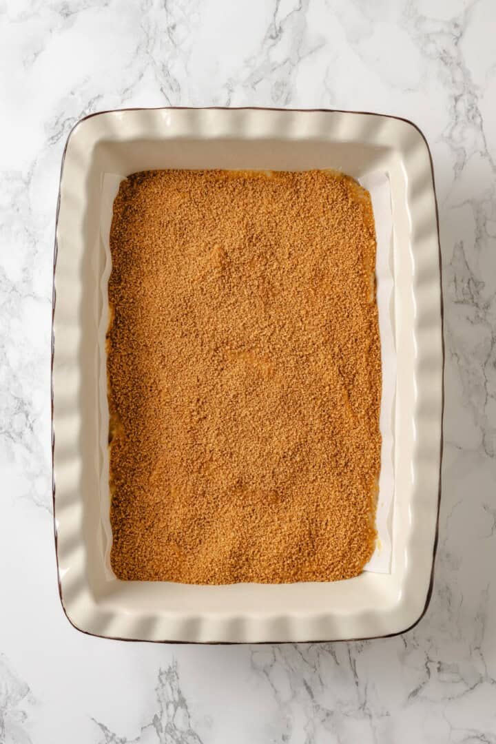 This vegan coffee cake recipe is a bakery-style treat! Moist and tender, with a cinnamon swirl and irresistible crumb topping. Delicious! Brown sugar cinnamon in baking dish for coffee cake.