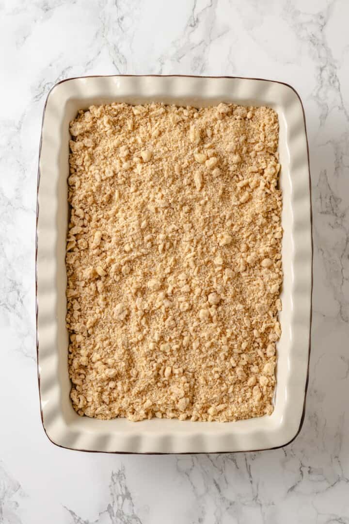 This vegan coffee cake recipe is a bakery-style treat! Moist and tender, with a cinnamon swirl and irresistible crumb topping. Delicious! Coffee cake in baking dish before baking.