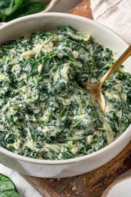 Creamed spinach in bowl with spoon.