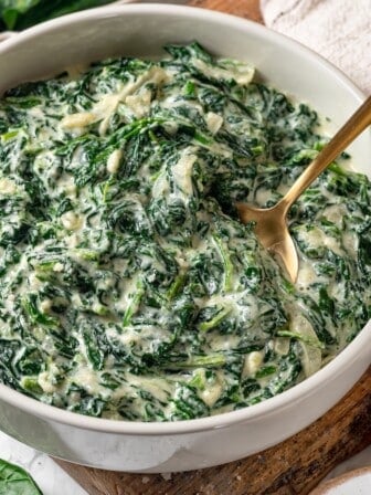 Creamed spinach in bowl with spoon.
