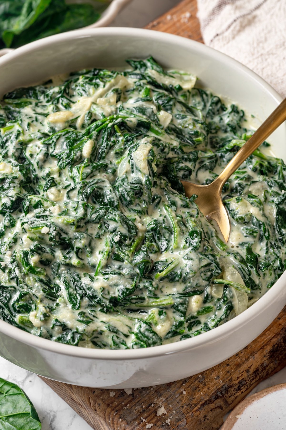 Creamed spinach in bowl with spoon.