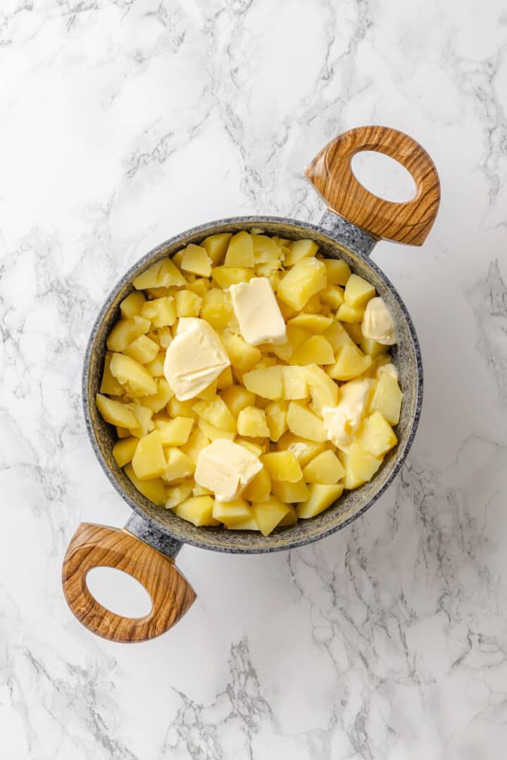 This vegan pierogi casserole layers a cheesy potato filling with lasagna noodles for pierogi vibes without the work of making dumplings! Butter added to pot of potatoes.