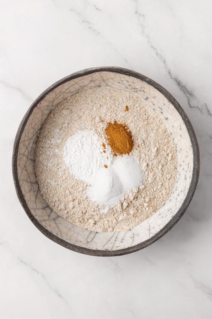 This moist vegan bran muffin recipe is made with whole wheat flour, raisins, and spiced with cinnamon for an easy, wholesome breakfast! Dry ingredients for bran muffins before whisking.