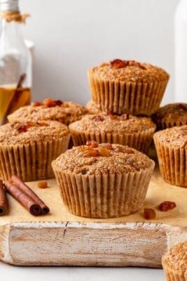 Pile of vegan bran muffins on cutting board.