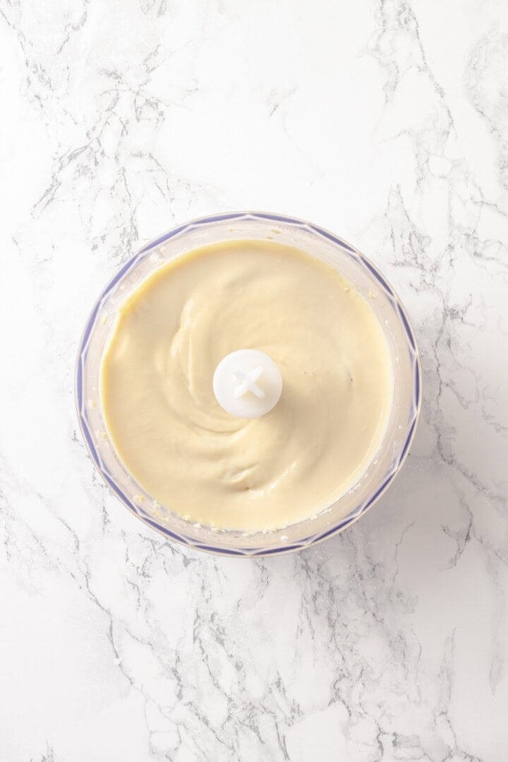 Silken Tofu Chocolate Mousse is the easiest vegan dessert you'll ever make! It's rich and indulgent, with a velvety smooth texture. So good! Pureed tofu in food processor bowl.