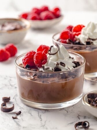 Vegan chocolate mousse made with silken tofu in two glass bowls.