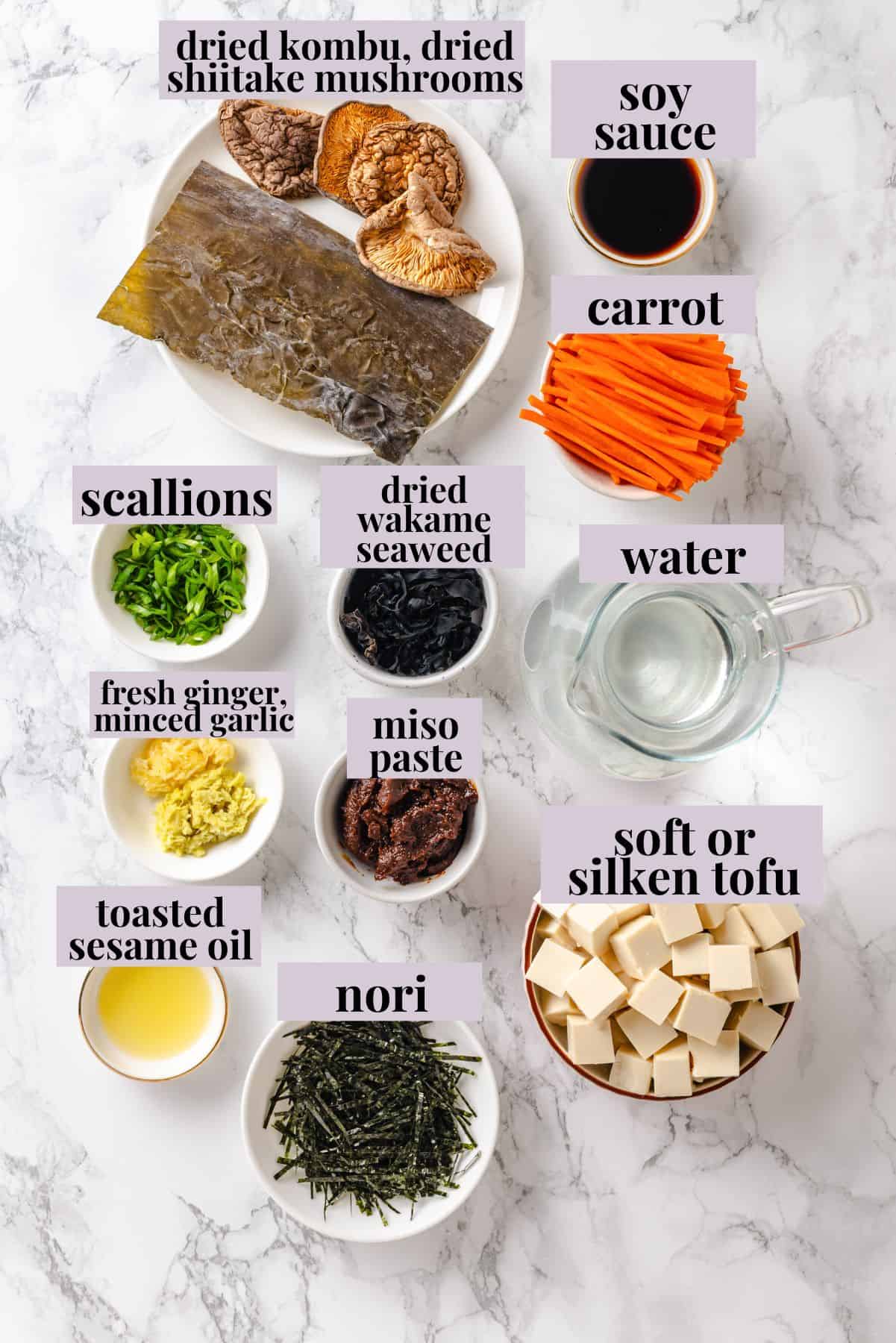 This cozy Miso Tofu Soup recipe is made with wakame, ginger, carrots and homemade dashi for a light, nourishing and flavorful vegan soup. Ingredients for miso tofu soup with labels.