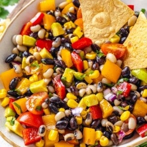 Two tortilla chips in bowl of cowboy caviar.