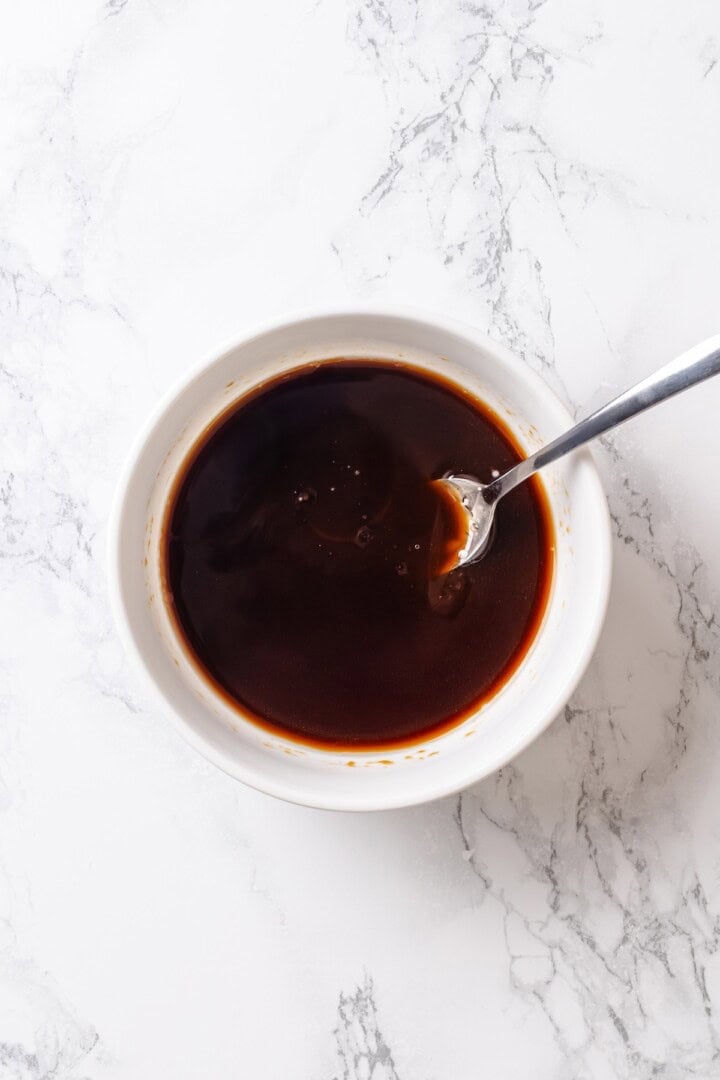 This crispy kung pao tofu is made with bell peppers, crunchy peanuts and a sweet-spicy sauce for a dinner that's even better than takeout! Bowl of kung pao sauce.