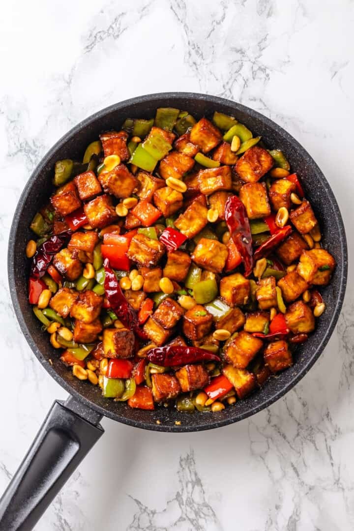 This crispy kung pao tofu is made with bell peppers, crunchy peanuts and a sweet-spicy sauce for a dinner that's even better than takeout! Skillet of kung pao tofu.