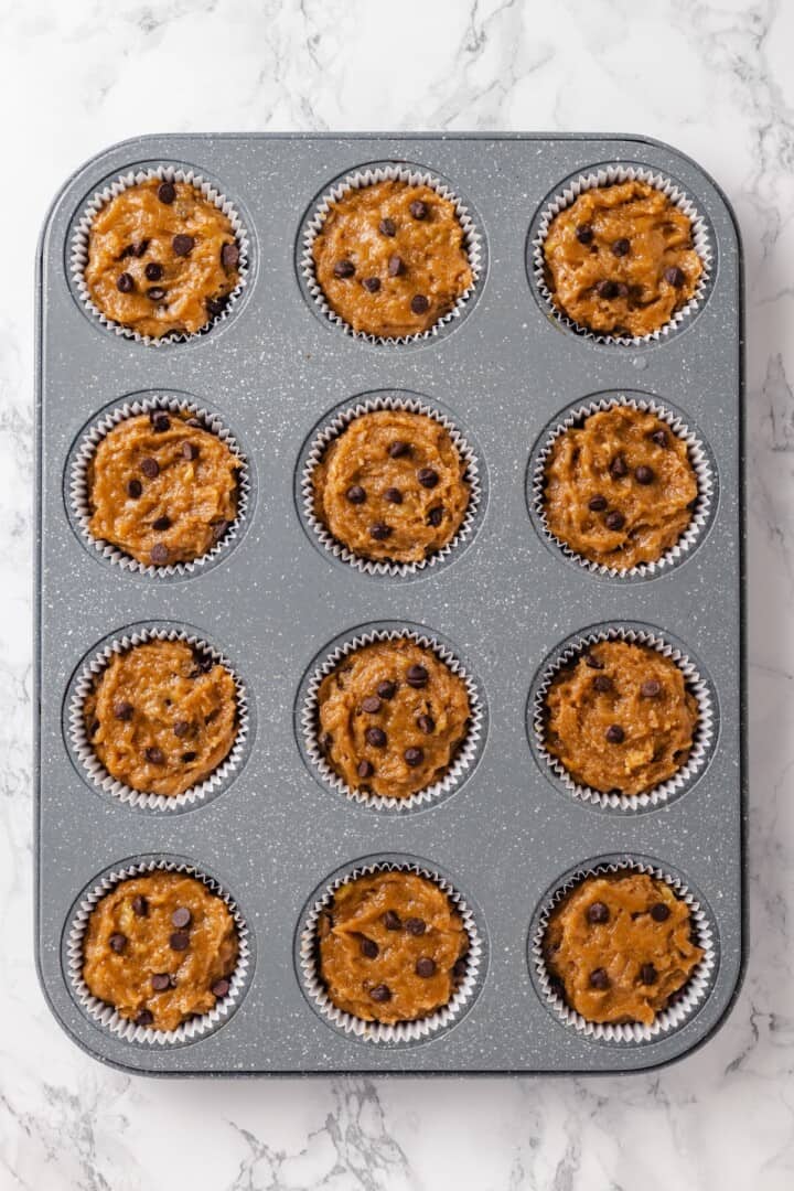 These moist peanut butter banana muffins are made with whole wheat flour and chocolate chips for a wholesome muffin that tastes like a treat! Unbaked peanut butter banana muffins.