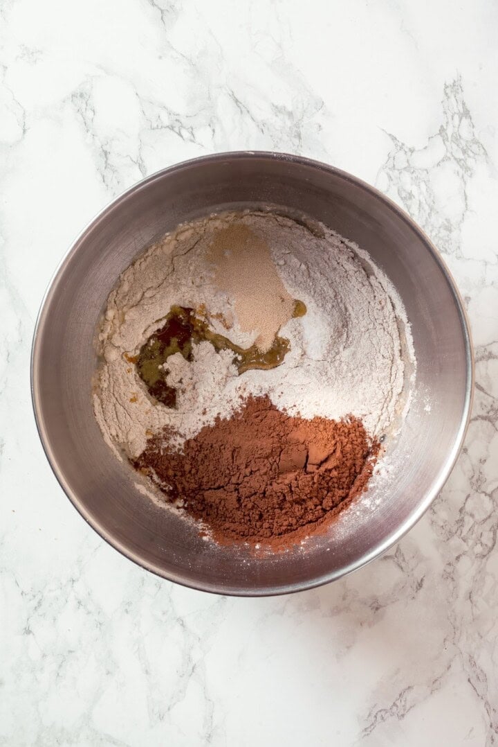 This no-knead dark pumpernickel bread has rich rye flavour and cocoa undertones, perfect for sandwiches and toast. It's so easy to make too! Dry ingredients for pumpernickel bread in bowl.