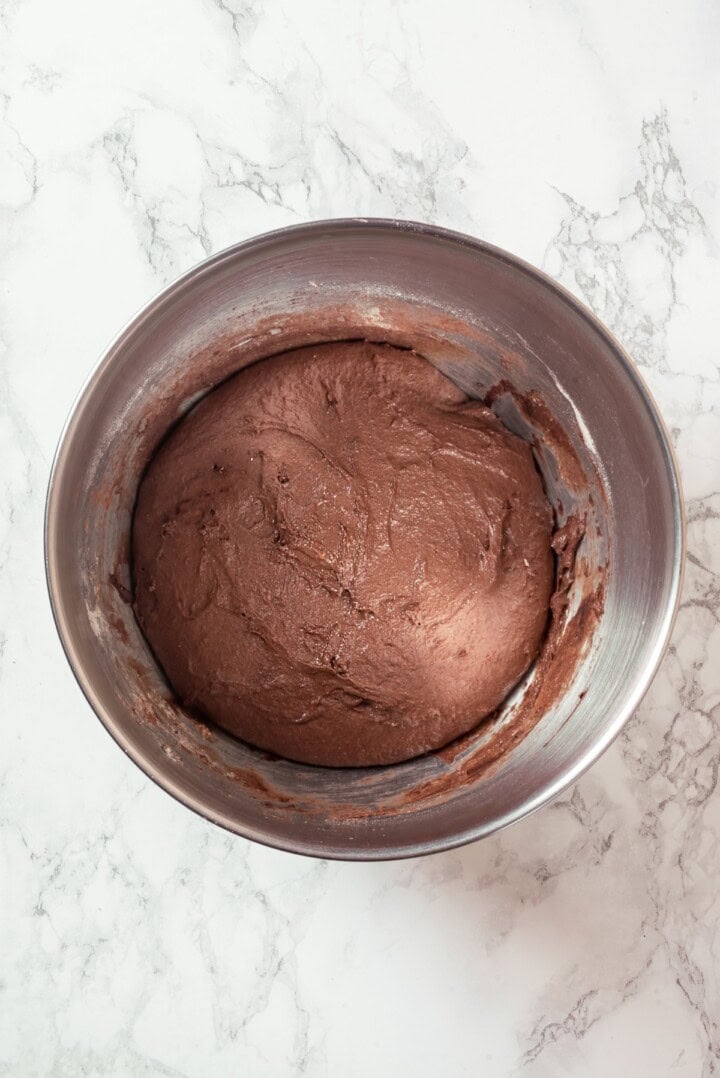 This no-knead dark pumpernickel bread has rich rye flavour and cocoa undertones, perfect for sandwiches and toast. It's so easy to make too! Pumpernickel dough in mixing bowl after rising.