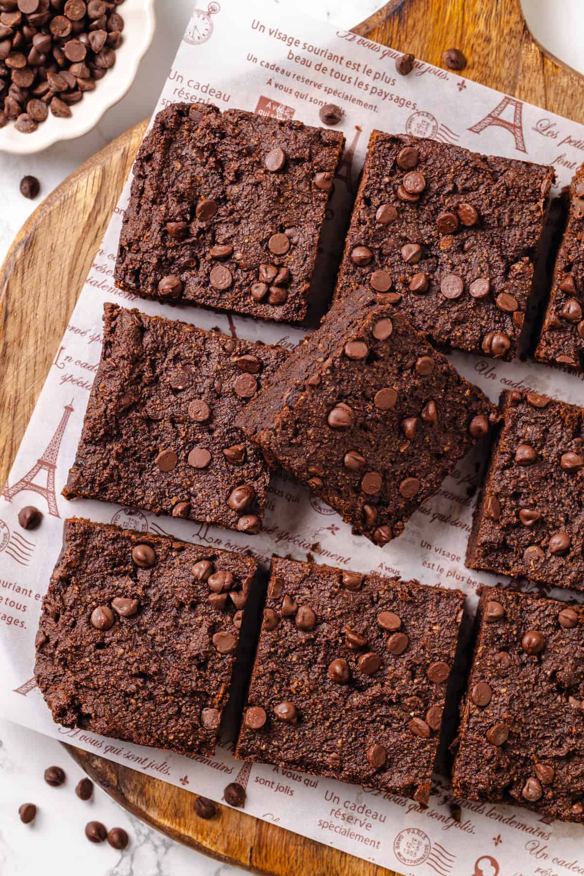 These fudgy vegan sweet potato brownies are made with maple syrup and cocoa for a treat that’s naturally sweet, gluten-free, and oh so rich! Cut sweet potato brownies on board with one brownie turned sideways to show thickness.