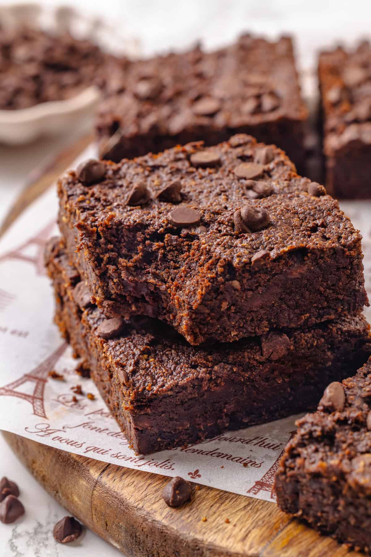 These fudgy vegan sweet potato brownies are made with maple syrup and cocoa for a treat that’s naturally sweet, gluten-free, and oh so rich! Stack of two sweet potato brownies with bite taken out of top brownie.
